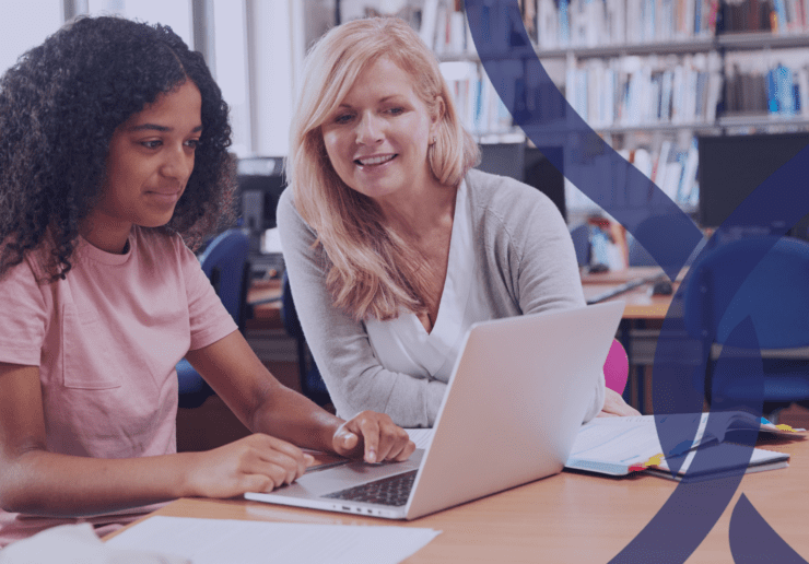 Teacher working with a teen girl on a laptop