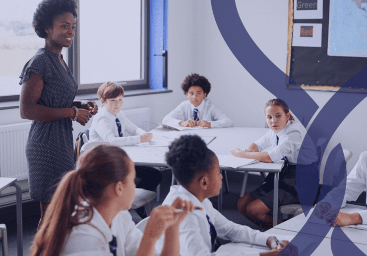Mixed race female teacher with a class of teenagers in school uniform