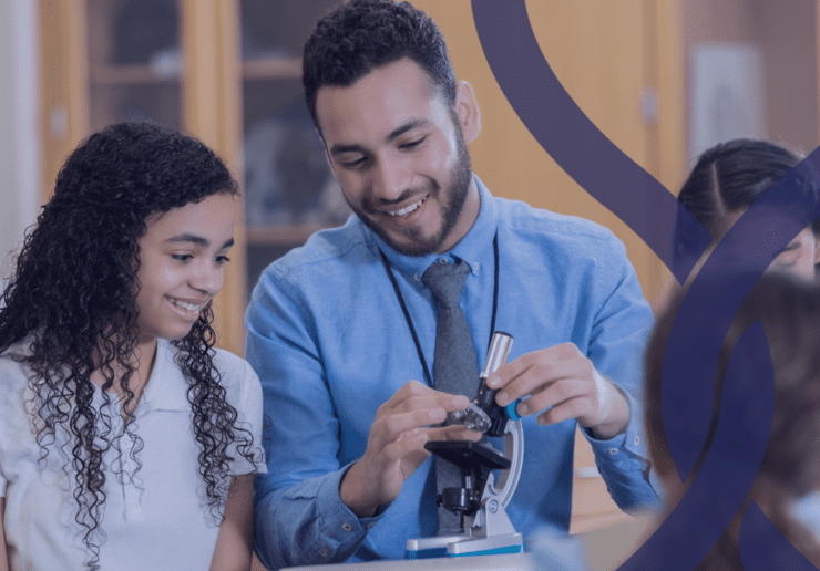 Teacher showing a teen child who to use a microscope