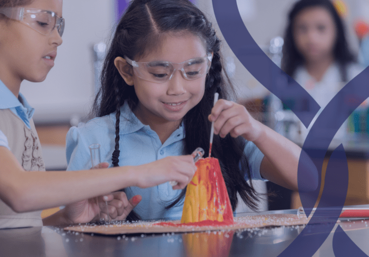 2 school girls painting a model volcano